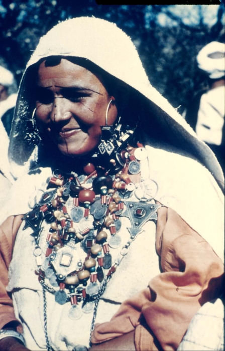 Amazigh woman with facial tattoos and traditional silver jewelry