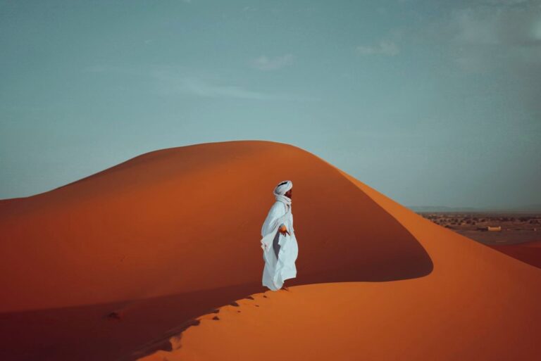 Berber man in traditional dress on the Sahara dunes near Merzouga