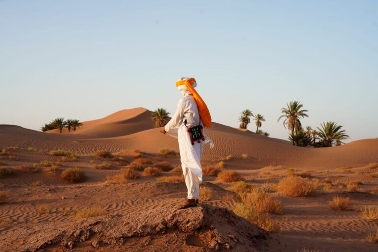 Berber man in traditional dress on the Sahara dunes near Merzouga