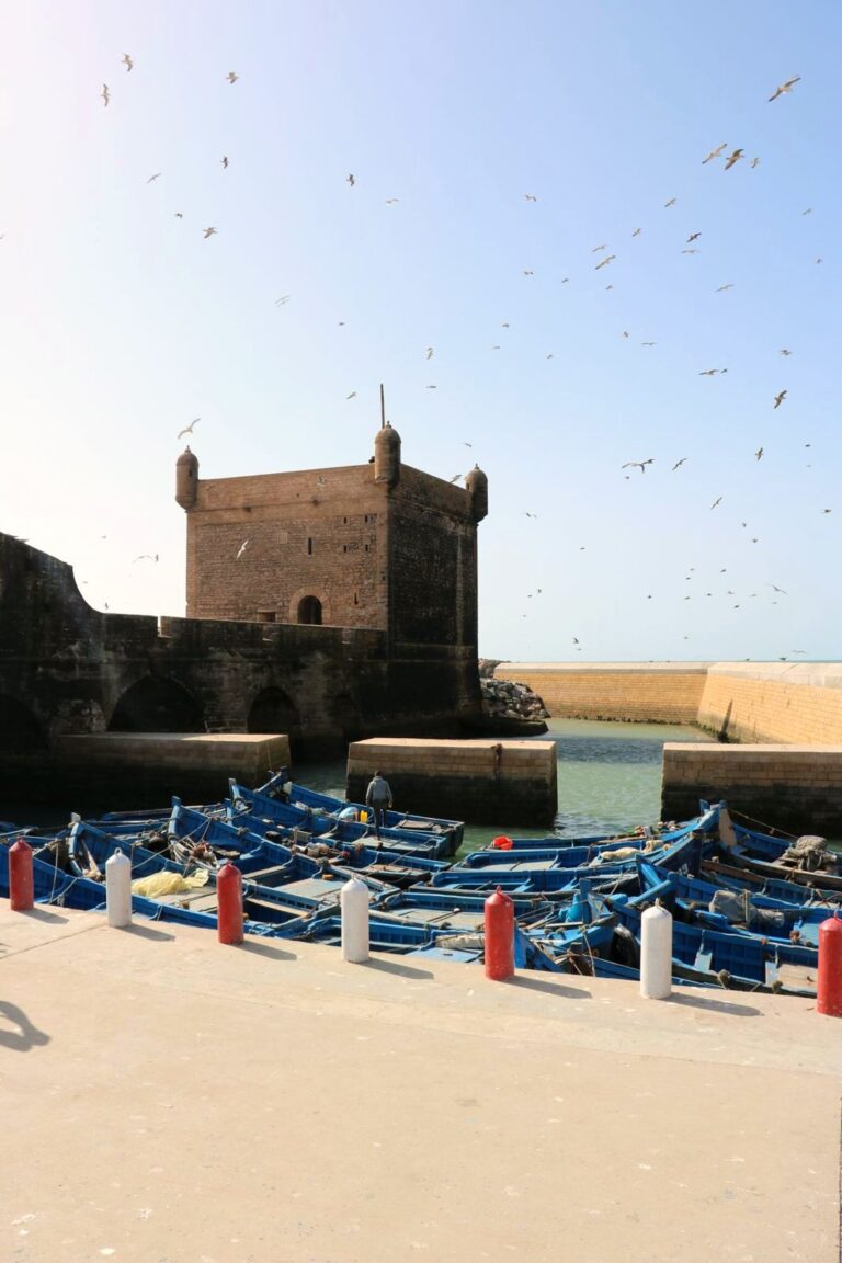 Essaouira port, blue fishing boats and Skala ramparts, Morocco