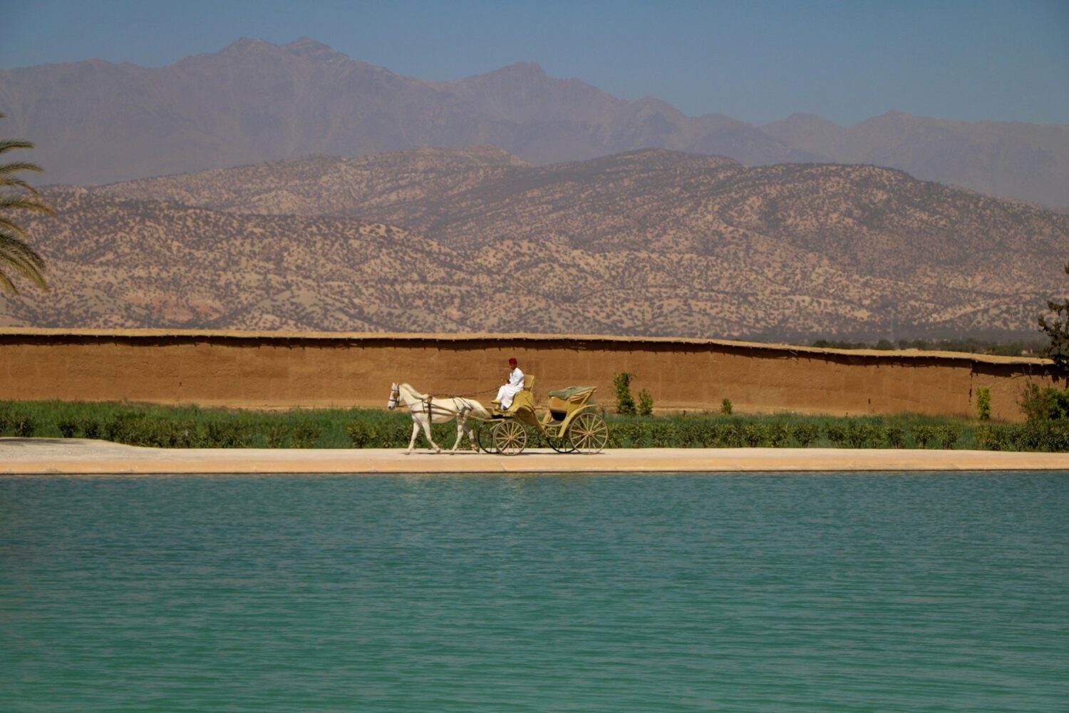 Horse carriage beside earthen ramparts in the Souss, Morocco