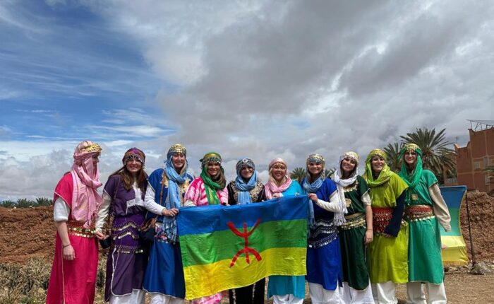 Students holding the Amazigh flag on a Morocco Cultours trip