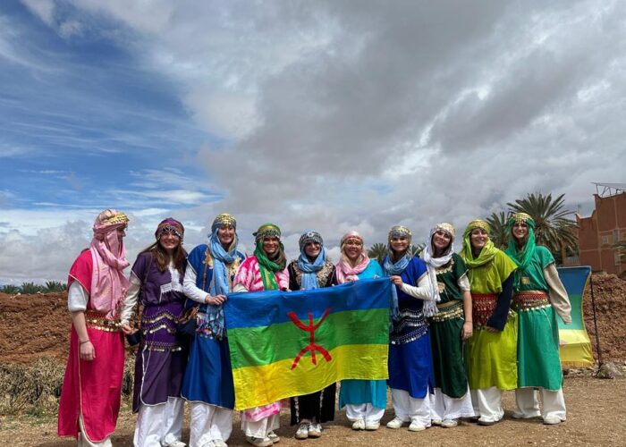 Students holding the Amazigh flag on a Morocco Cultours trip