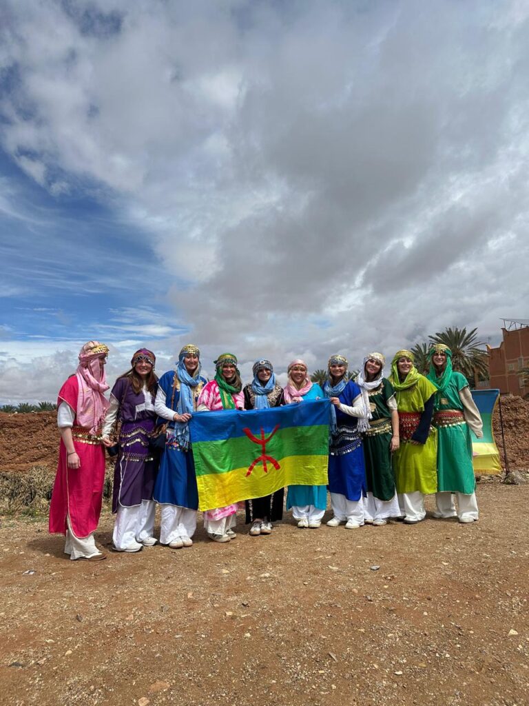Students holding the Amazigh flag on a Morocco Cultours trip