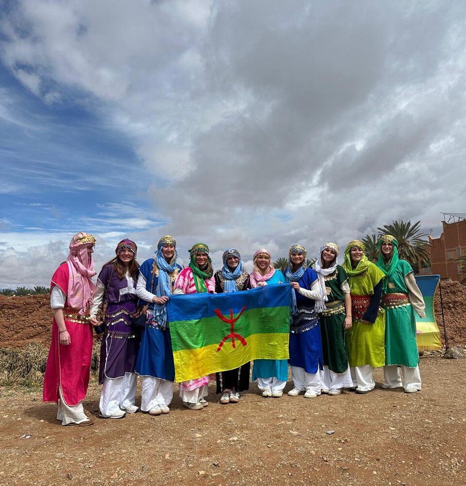Students holding the Amazigh flag on a Morocco Cultours trip