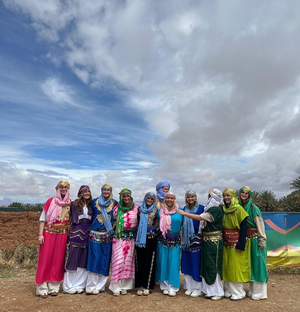 Student group dressed in traditional Berber clothes in a southern oasis