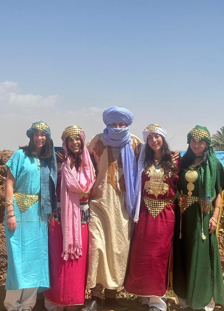 Students in traditional Berber dress with their guide
