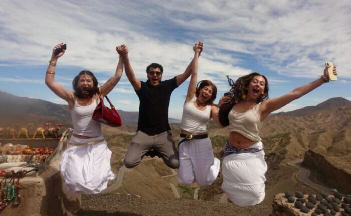 Students jumping for joy at the Tizi n'Tichka pass in the High Atlas
