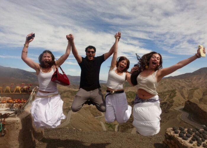 Students jumping for joy at the Tizi n'Tichka pass in the High Atlas