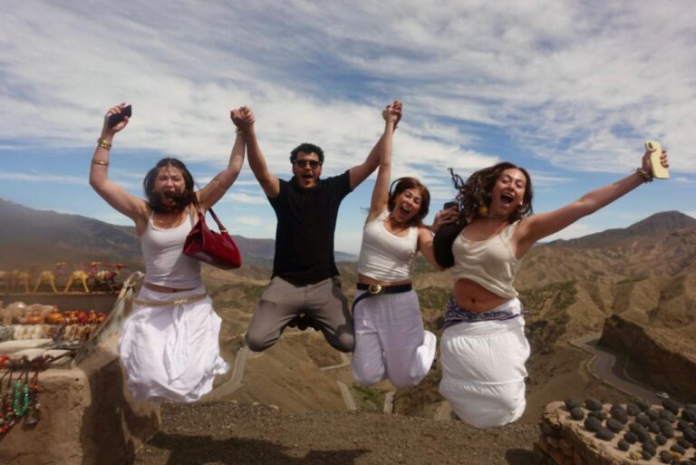 Students jumping for joy at the Tizi n'Tichka pass in the High Atlas