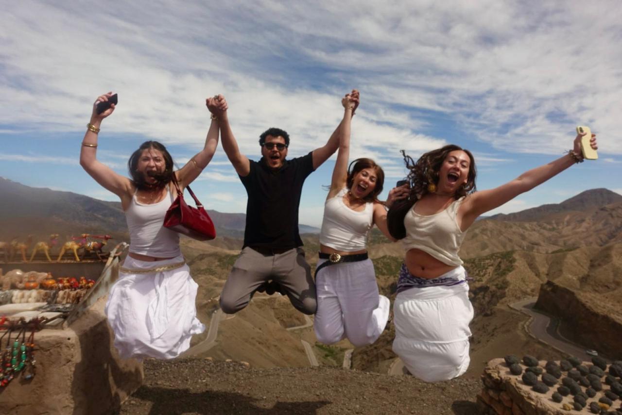 Students jumping for joy at the Tizi n'Tichka pass in the High Atlas