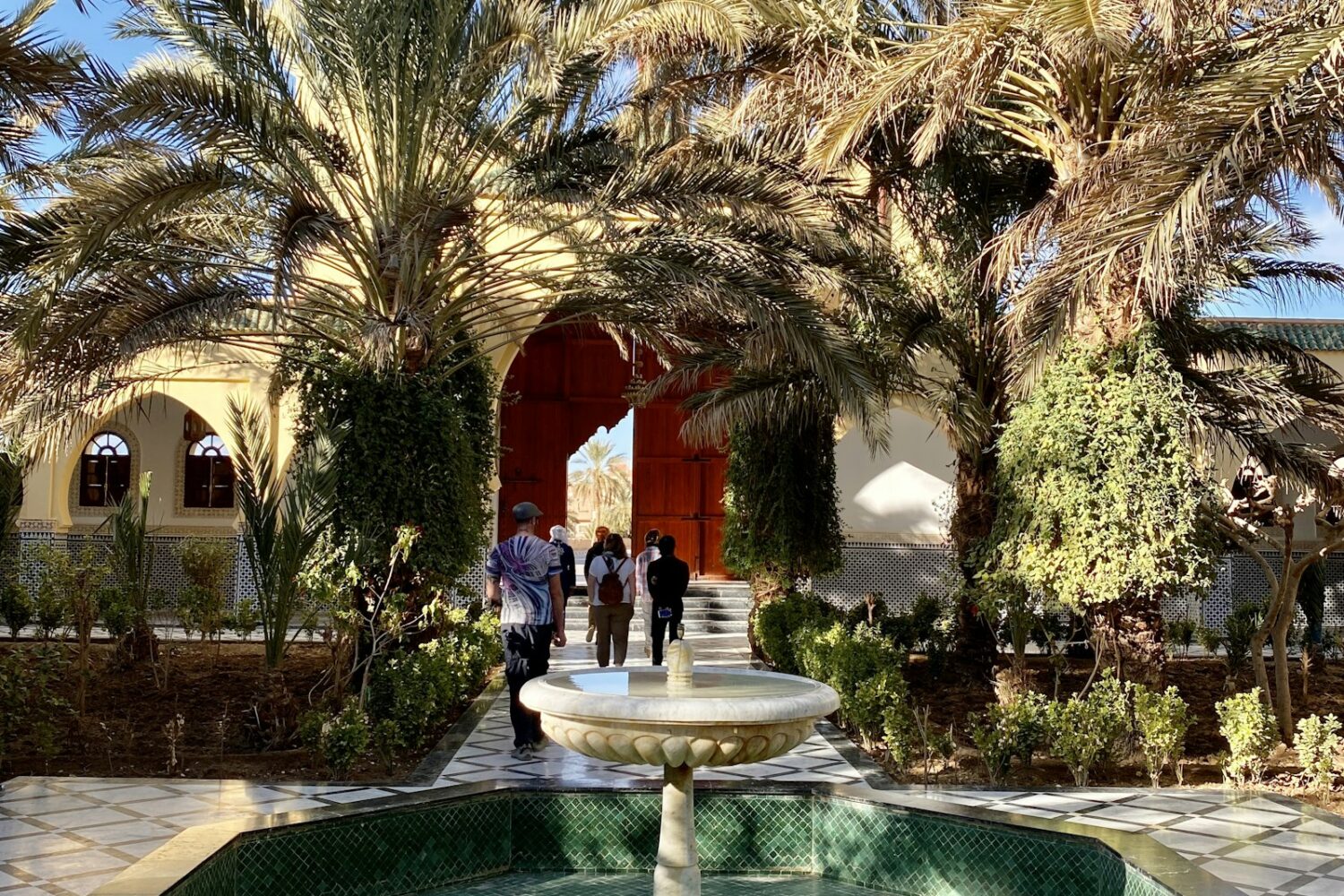 Courtyard with a fountain and palm trees in Rissani