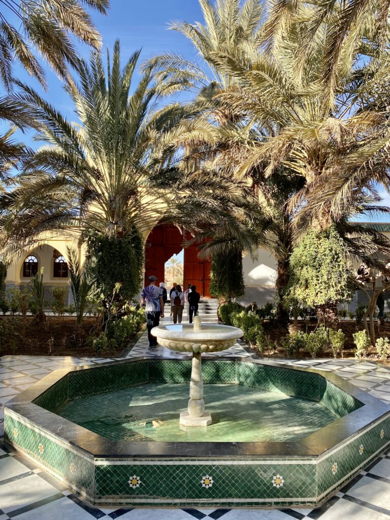 Courtyard with a fountain and palm trees in Rissani