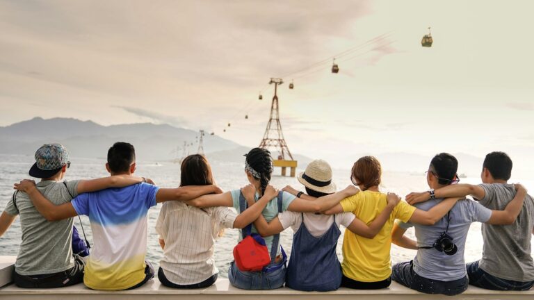 Friends sitting together at sunset